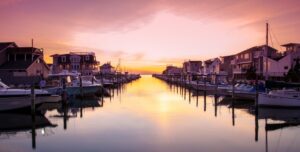 lbi-bayfront-homes-sunset-real-estate Bayfront homes and boat docks along a Long Beach Island lagoon at sunset, New Jersey